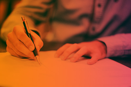 photo of person signing a document
